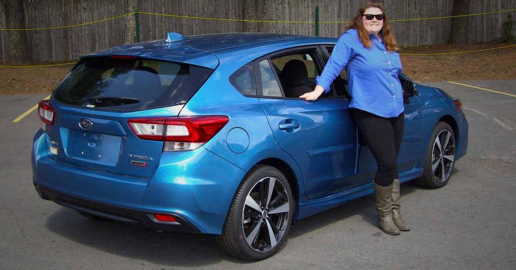 Amber stands by her favorite vehicle, the Subaru Impreza Sport 5 Door