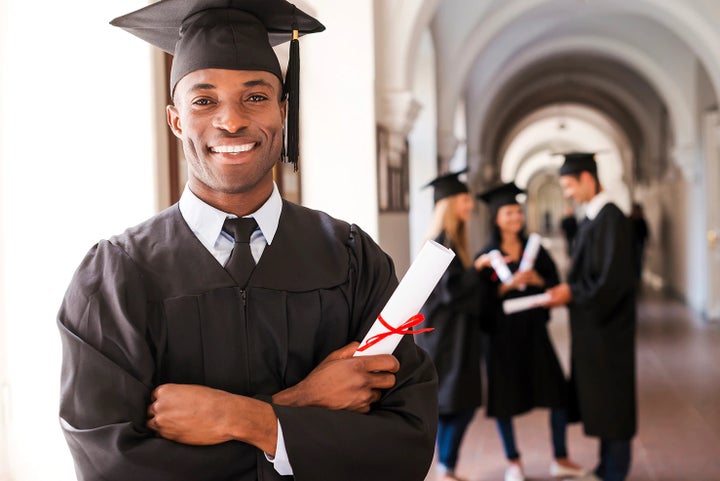 college graduate holding his diploma | Goldstein Subaru in Colonie NY