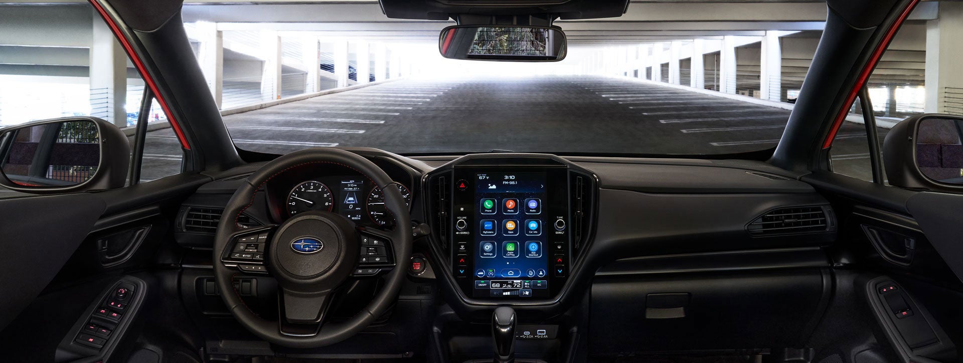Interior view of a 2024 Subaru steering wheel, dashboard, media touchscreen and glovebox